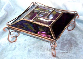 This glass jewelry box has a very special shape and adourned with fancy wirework