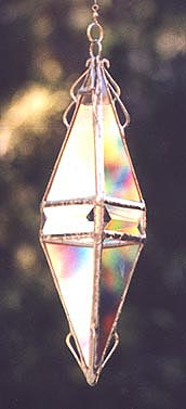 Platonic golden triangles and a beveled band enhance the rainbow effects.