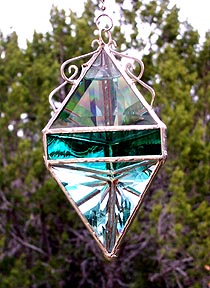 Wavy teal jewel tones accent this large beveled pendant.