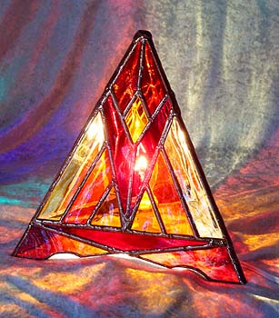 The Sunglow Pyramid Lamp radiates fiery hot colors